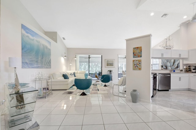 living room featuring a ceiling fan and light tile patterned floors