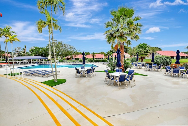 community pool featuring a patio and outdoor dining space