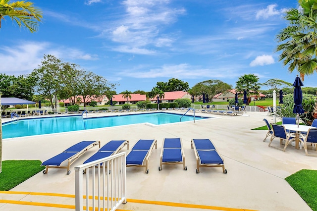 community pool featuring a patio area and fence