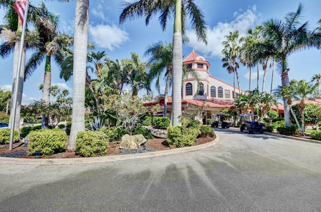 view of property featuring asphalt driveway and a carport