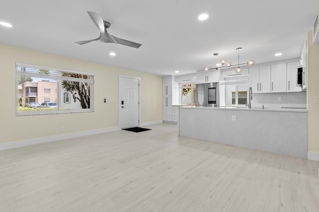 969 Normandy U, Delray Beach, FL 33484 - unfurnished living room with recessed lighting, light wood-type flooring, a ceiling fan, and baseboards