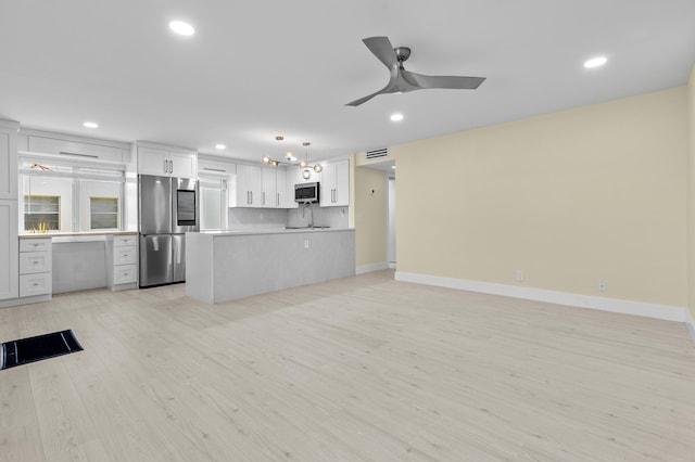 969 Normandy U, Delray Beach, FL 33484 - kitchen featuring appliances with stainless steel finishes, open floor plan, recessed lighting, light wood-style flooring, and ceiling fan