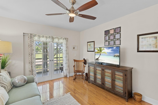 sitting room with french doors, wood finished floors, a ceiling fan, and baseboards