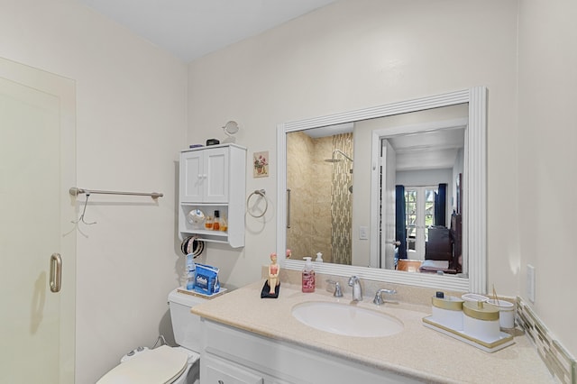 bathroom featuring a shower, vanity, and toilet