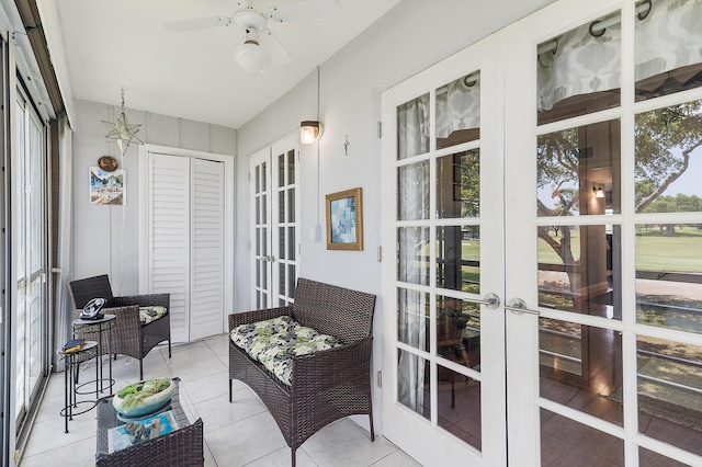 sunroom / solarium with french doors and a ceiling fan