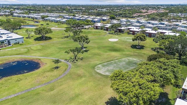 drone / aerial view of a golf club and a nearby body of water