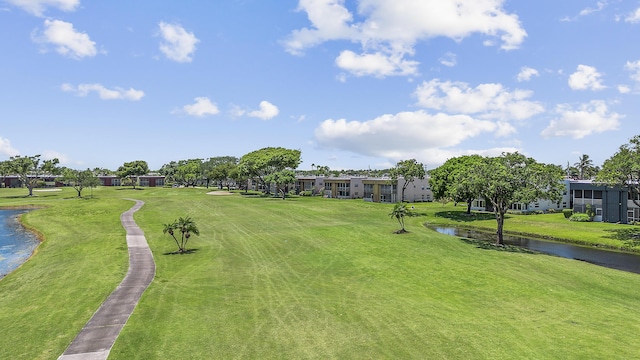 view of home's community featuring a water view and a lawn