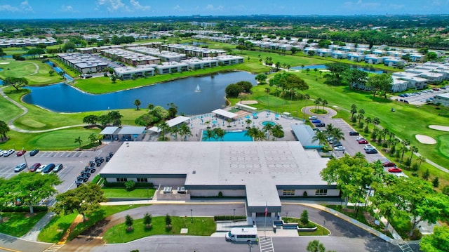 aerial view of a golf club, a large body of water, and apartment complex