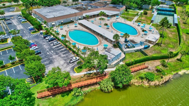 aerial view of a pool area and a large body of water