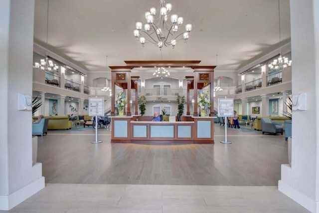 reception featuring a chandelier and crown molding