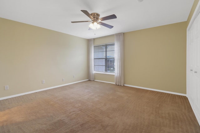 unfurnished room featuring ceiling fan, baseboards, and carpet floors