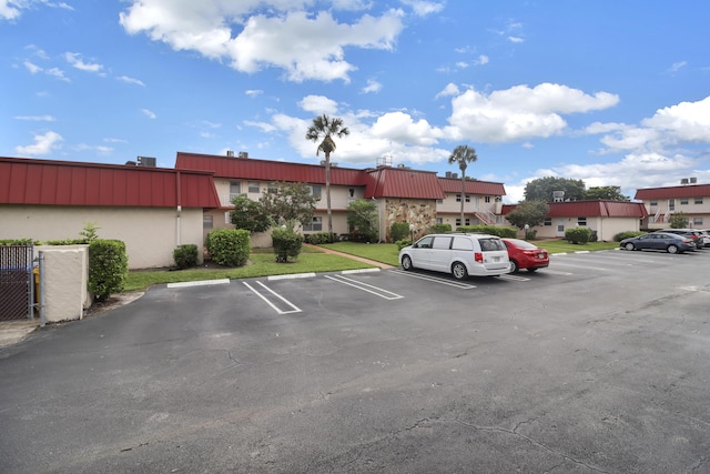 uncovered parking lot with a residential view