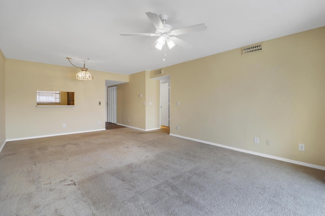 spare room with ceiling fan, carpet flooring, and baseboards