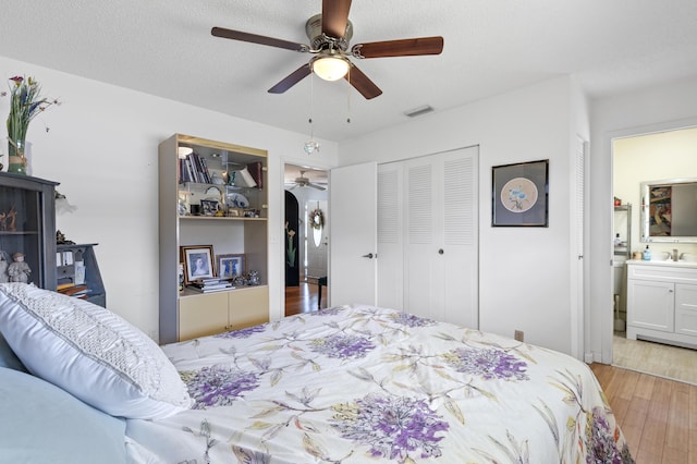249 Cardinal Ln, Delray Beach, FL 33445 - bedroom featuring light wood-style floors, a closet, ceiling fan, and a sink