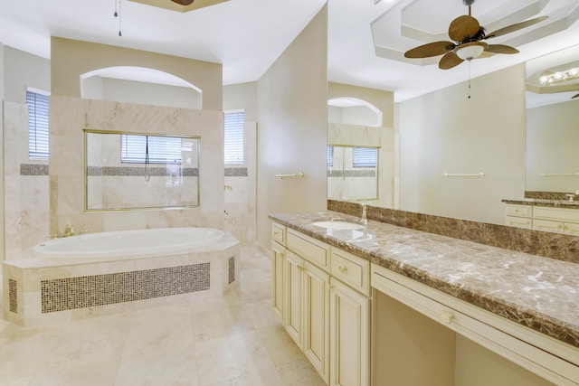 full bath featuring ceiling fan, plenty of natural light, a bath, and tiled shower