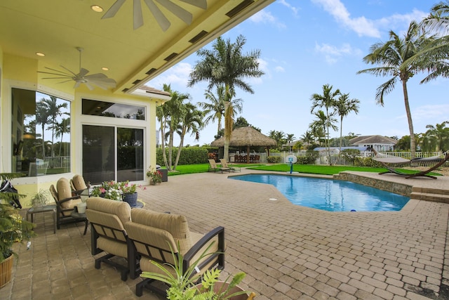 view of swimming pool featuring a gazebo, ceiling fan, a patio, a fenced backyard, and an outdoor hangout area