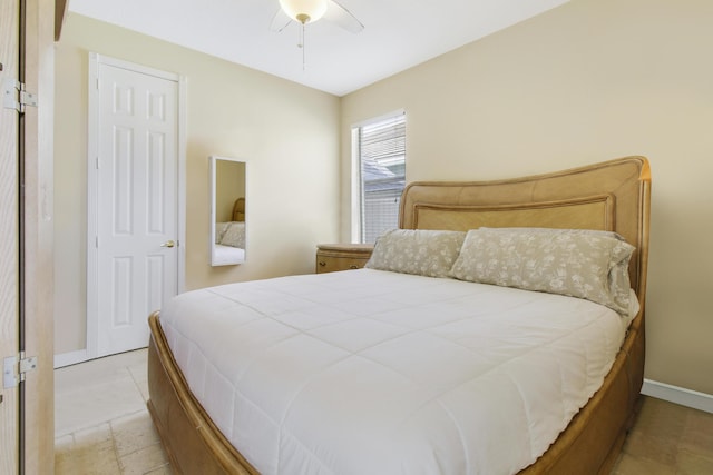bedroom featuring baseboards and ceiling fan