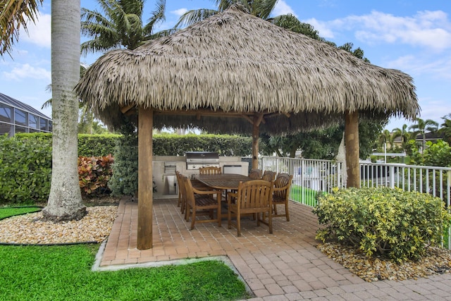view of patio featuring area for grilling, a gazebo, outdoor dining space, a grill, and fence