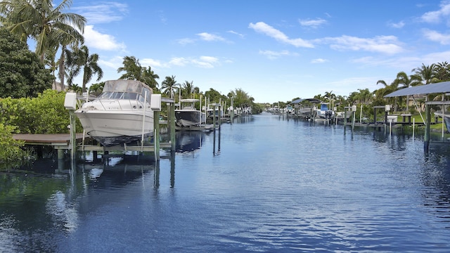 dock area with boat lift and a water view