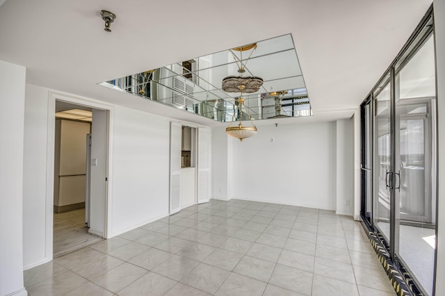 123 Lakeshore Dr Unit 1644, North Palm Beach, FL 33408 - empty room with baseboards and light tile patterned floors