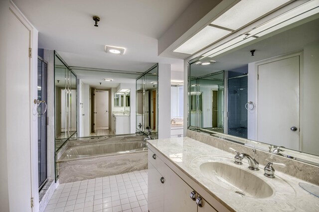 123 Lakeshore Dr Unit 1644, North Palm Beach, FL 33408 - bathroom featuring a stall shower, a bath, vanity, and tile patterned flooring
