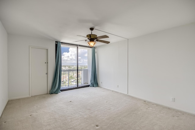123 Lakeshore Dr Unit 1644, North Palm Beach, FL 33408 - carpeted empty room featuring expansive windows, ceiling fan, and baseboards