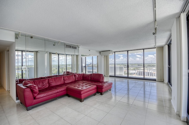 123 Lakeshore Dr Unit 1644, North Palm Beach, FL 33408 - living area featuring track lighting, a textured ceiling, a wall unit AC, a wall of windows, and a water view