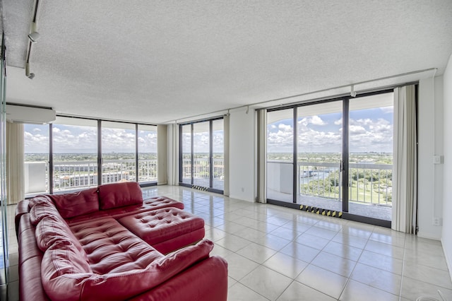 123 Lakeshore Dr Unit 1644, North Palm Beach, FL 33408 - living area featuring floor to ceiling windows, a textured ceiling, and light tile patterned floors