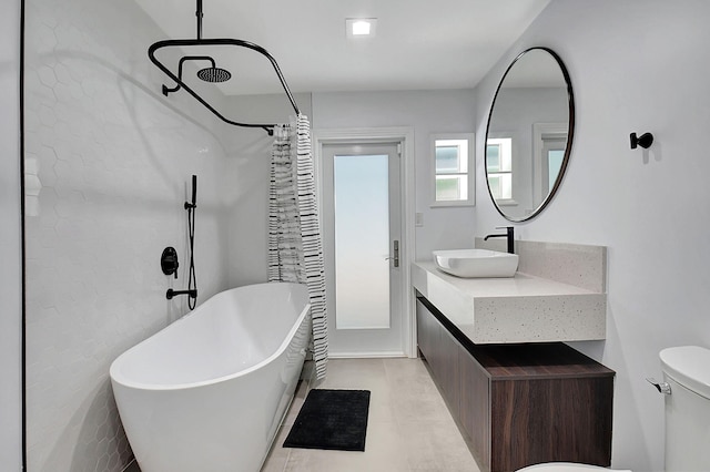 full bathroom featuring a soaking tub, toilet, vanity, and curtained shower