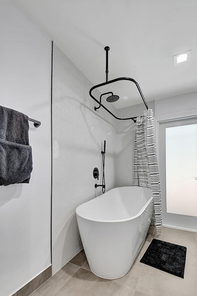 full bathroom with a soaking tub, a shower, and tile patterned floors