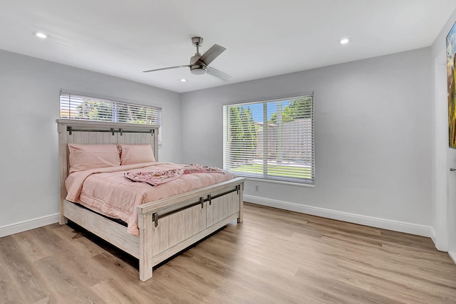 bedroom featuring baseboards, light wood finished floors, a ceiling fan, and recessed lighting