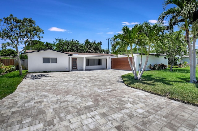 single story home with driveway and stucco siding