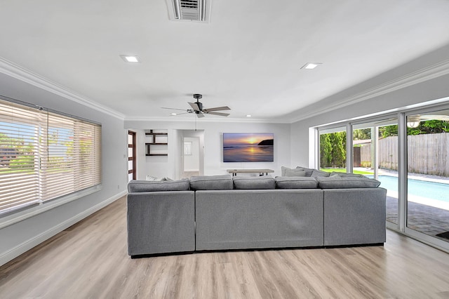 living area featuring crown molding, light wood-style flooring, baseboards, a ceiling fan, and recessed lighting