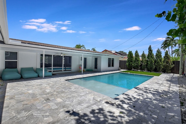 view of swimming pool with a ceiling fan, a patio area, and a fenced backyard