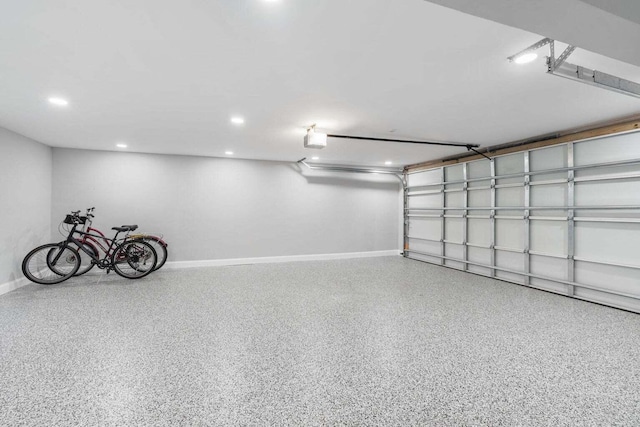 garage with baseboards, a garage door opener, and recessed lighting