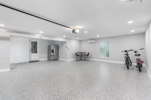garage featuring stainless steel refrigerator with ice dispenser, recessed lighting, baseboards, an AC wall unit, and a garage door opener