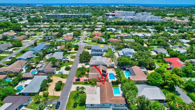 view of property location with a pool and nearby suburban area