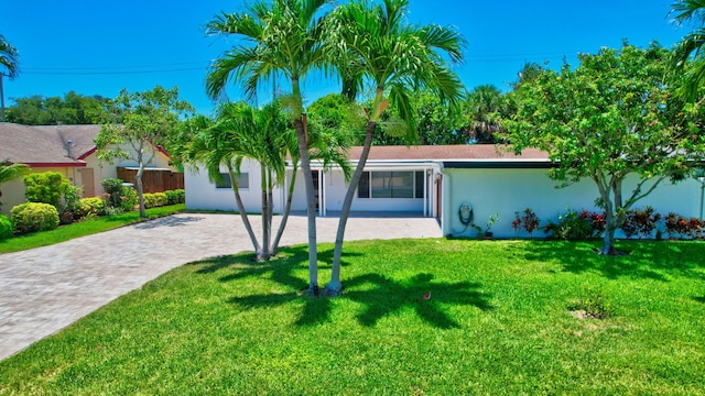 view of front of property with stucco siding and a front lawn