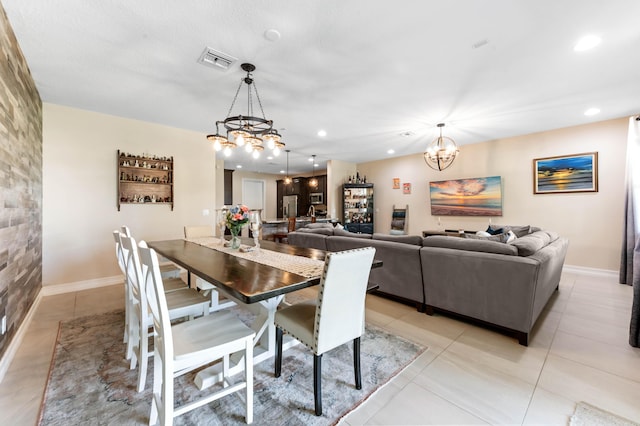 dining space featuring a chandelier, recessed lighting, light tile patterned flooring, and baseboards