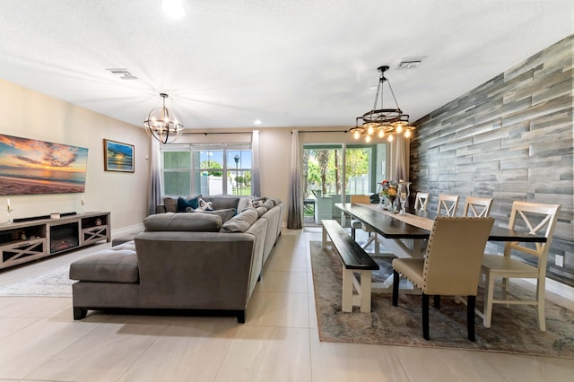 dining area with a chandelier, light tile patterned floors, and recessed lighting