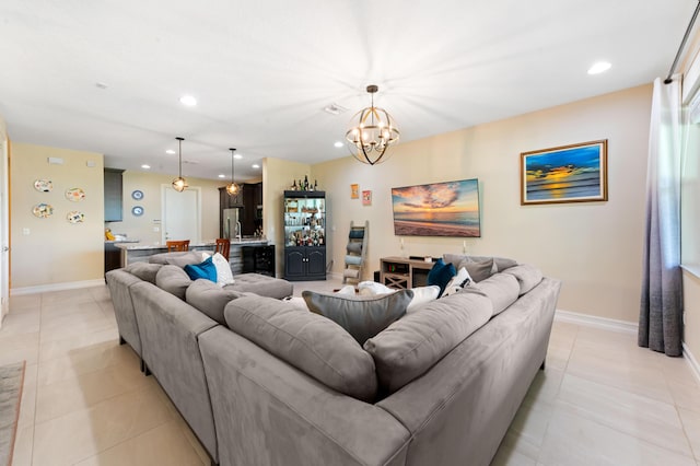 living room featuring a chandelier, recessed lighting, baseboards, and light tile patterned flooring