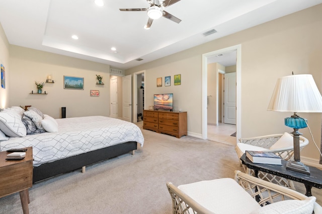 bedroom featuring light carpet, recessed lighting, baseboards, a raised ceiling, and ceiling fan