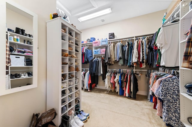 spacious closet with carpet and attic access