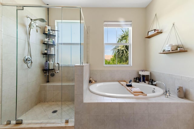 bathroom with a stall shower and a bath