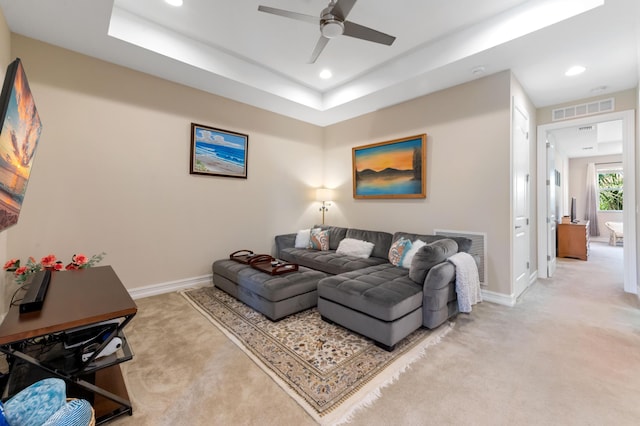 living room featuring carpet flooring, ceiling fan, recessed lighting, baseboards, and a raised ceiling