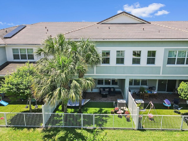 rear view of house featuring a tiled roof, a patio, central AC unit, and outdoor lounge area