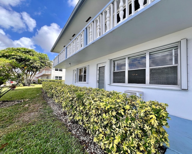 view of property exterior with stucco siding and a balcony