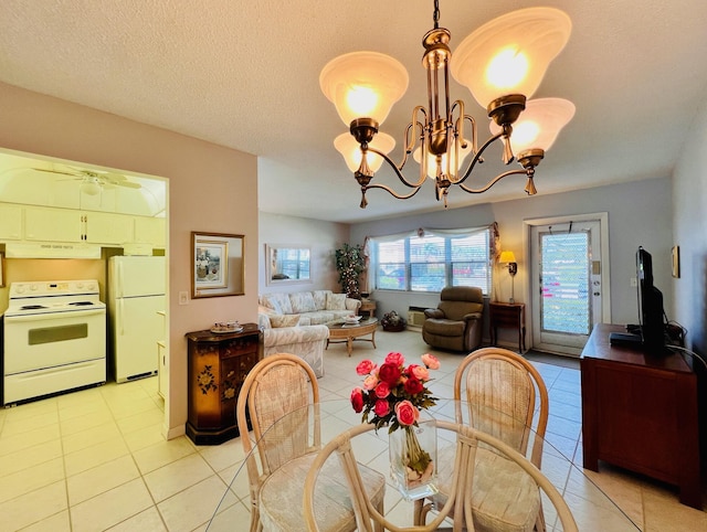 dining area with light tile patterned flooring and a chandelier