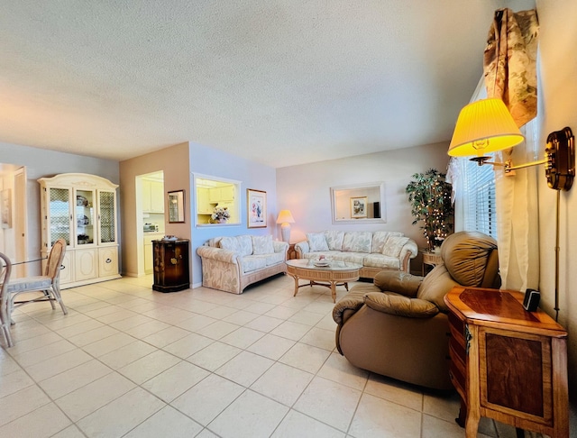 living area with light tile patterned floors and a textured ceiling