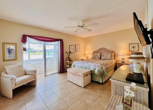 bedroom featuring access to outside, light tile patterned floors, and a ceiling fan